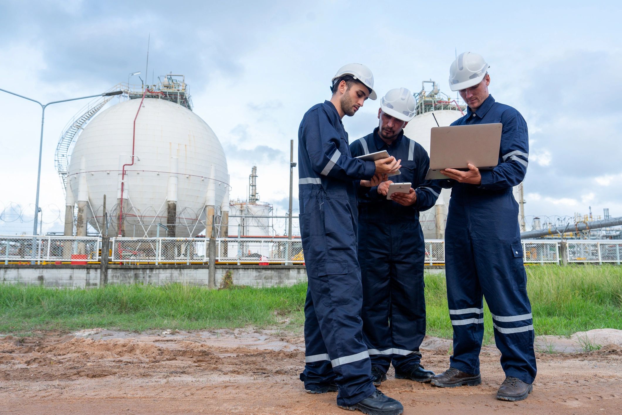 Oil and gas professionals reviewing plans at a petrochemical facility